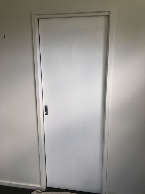 White interior door set in a plain white wall